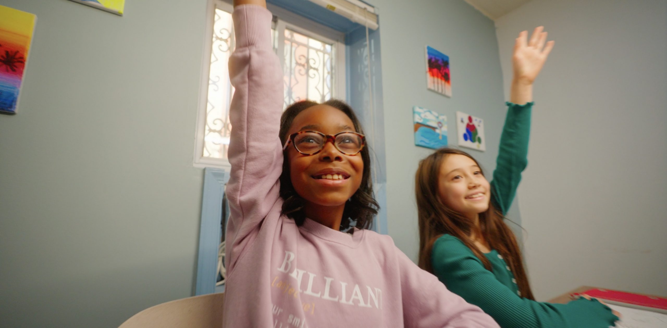 Girl raises hand in classroom